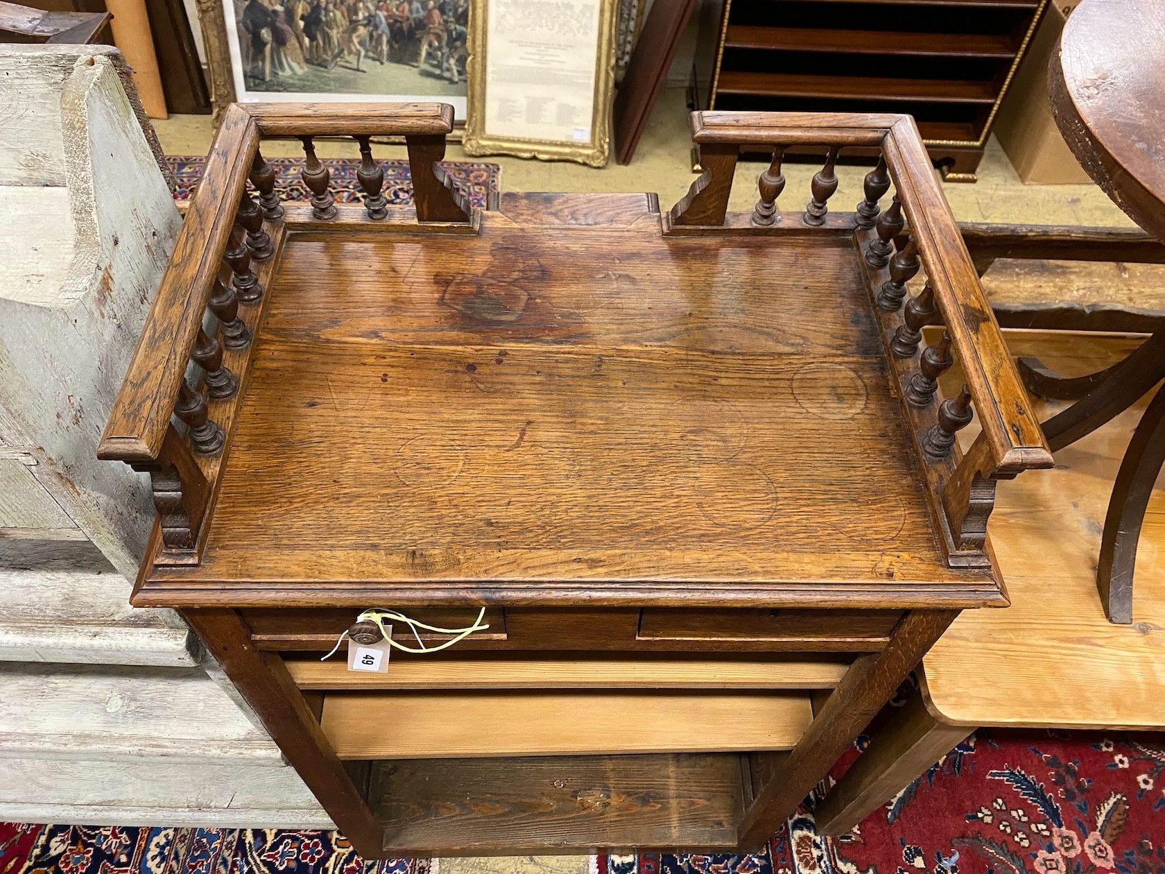 An early 20th century French oak clerk's desk, width 70cm, depth 50cm, height 112cm
